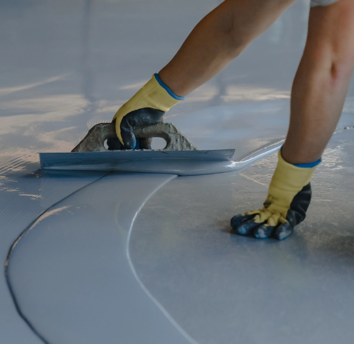 worker applying epoxy coating aurora co